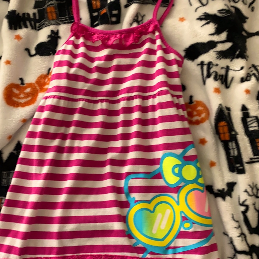This is a hello kitty dress with pink and white stripes. It's in good condition.